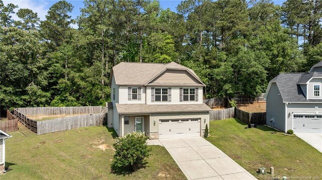 4572 Headwind Dr, Fayetteville, NC 28306 - view of front of house with driveway, an attached garage, and stone siding