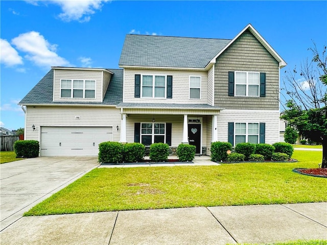 196 Wedgefield Dr, Raeford, NC 28376 - view of front of home featuring driveway, a front yard, a garage, a porch, and a shingled roof
