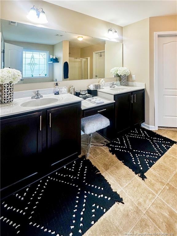 196 Wedgefield Dr, Raeford, NC 28376 - bathroom featuring vanity, tile patterned floors, and a shower stall