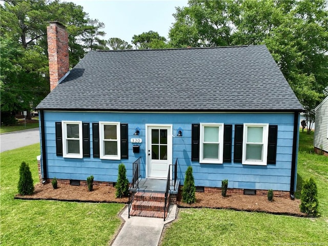 view of front of house with a chimney, a front lawn, a shingled roof, and crawl space