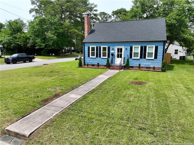 view of front facade featuring crawl space, a chimney, a front yard, and a shingled roof
