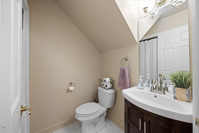 bathroom featuring toilet, tile patterned floors, vanity, baseboards, and lofted ceiling