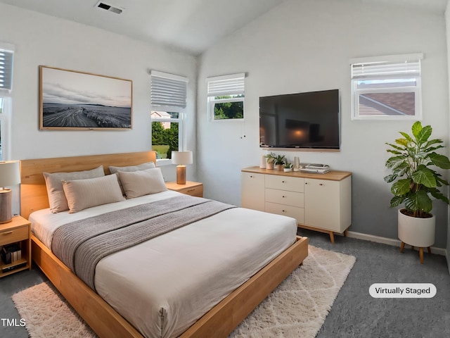 8891 Commons Townes Dr, Raleigh, NC 27616 - carpeted bedroom featuring vaulted ceiling and baseboards