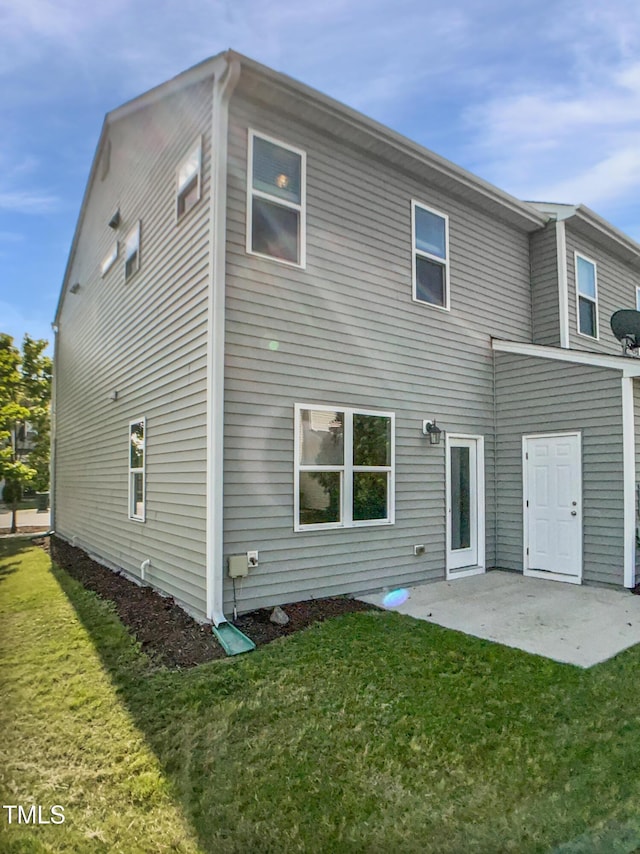 8891 Commons Townes Dr, Raleigh, NC 27616 - back of property with a lawn and a patio area