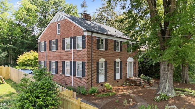925 S Chestnut St, Henderson, NC 27536 - view of front of house featuring fence, brick siding, a chimney, and crawl space
