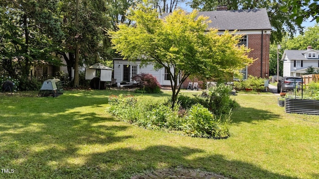 925 S Chestnut St, Henderson, NC 27536 - view of grassy yard featuring a vegetable garden