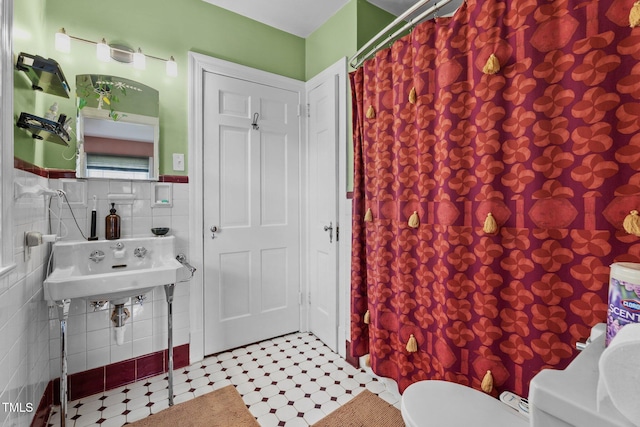 925 S Chestnut St, Henderson, NC 27536 - full bathroom featuring tile walls, curtained shower, toilet, and a wainscoted wall
