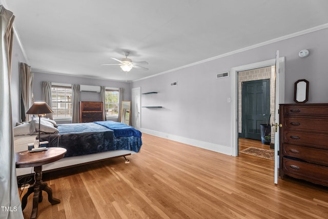 925 S Chestnut St, Henderson, NC 27536 - bedroom featuring a wall unit AC, ornamental molding, light wood-style floors, baseboards, and a ceiling fan