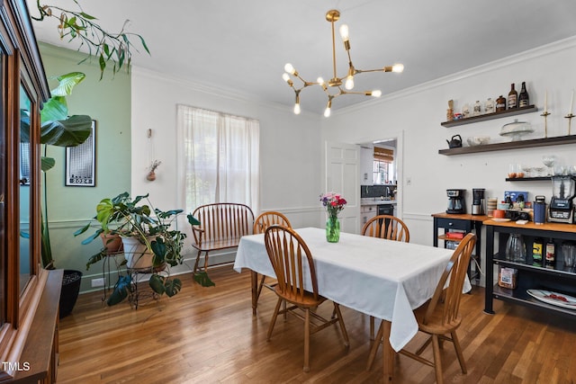 925 S Chestnut St, Henderson, NC 27536 - dining space featuring ornamental molding, a chandelier, healthy amount of natural light, and wood finished floors