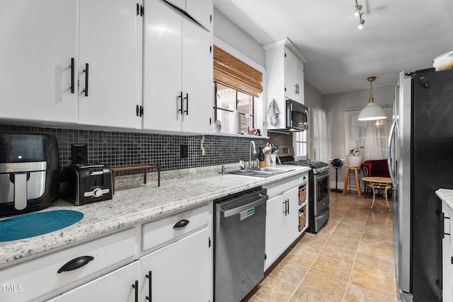 925 S Chestnut St, Henderson, NC 27536 - kitchen featuring appliances with stainless steel finishes, a sink, tasteful backsplash, and white cabinetry