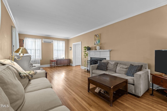 925 S Chestnut St, Henderson, NC 27536 - living room featuring light wood-type flooring, a wall mounted air conditioner, crown molding, a fireplace, and baseboards