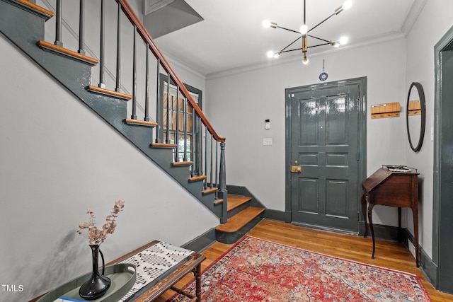 925 S Chestnut St, Henderson, NC 27536 - foyer entrance featuring ornamental molding, wood finished floors, a chandelier, stairs, and baseboards