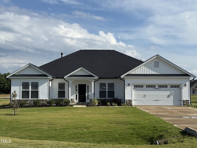 view of front of property featuring stone siding, an attached garage, concrete driveway, and a front lawn