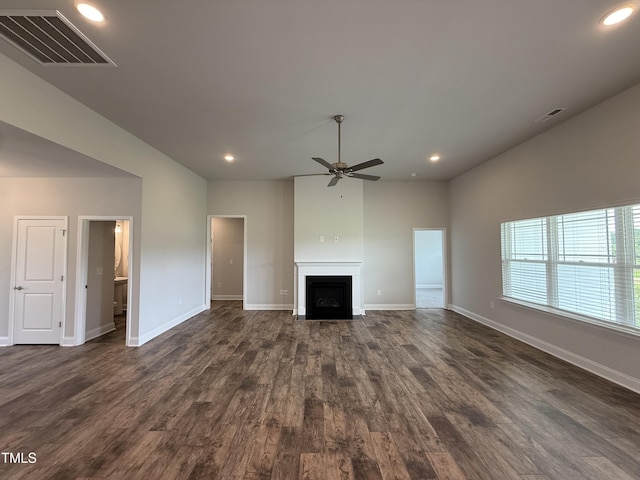 unfurnished living room featuring a ceiling fan, recessed lighting, dark wood-type flooring, a fireplace with flush hearth, and baseboards