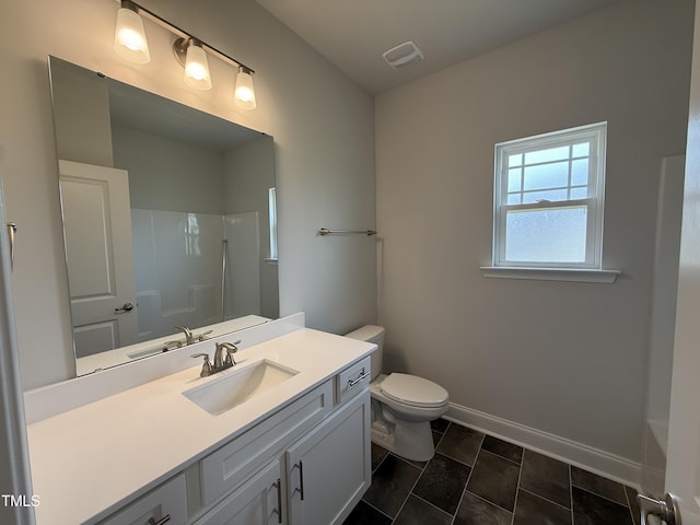 full bath featuring a shower, vanity, toilet, baseboards, and tile patterned flooring
