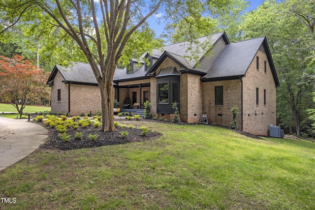 view of front facade featuring brick siding, cooling unit, a front lawn, and crawl space