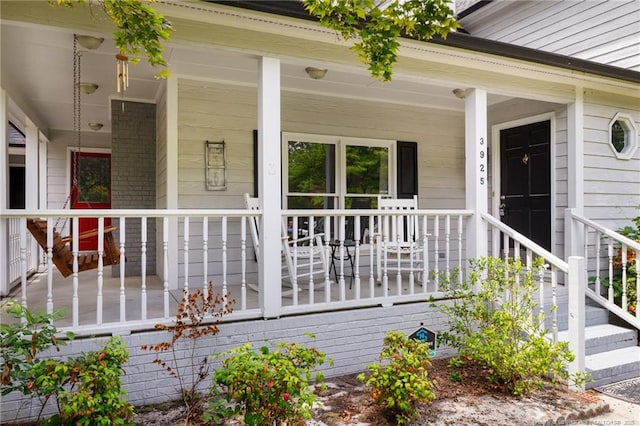 view of exterior entry with covered porch
