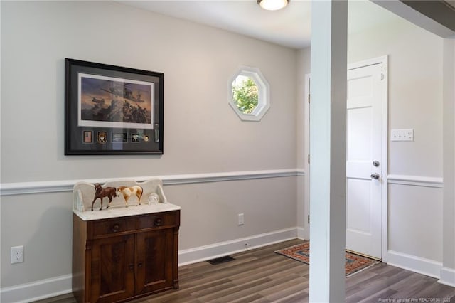 entryway featuring dark wood-style flooring and baseboards