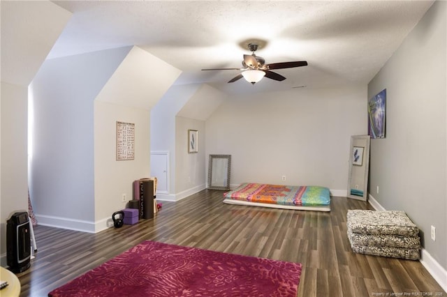 bedroom featuring wood finished floors, baseboards, vaulted ceiling, and ceiling fan
