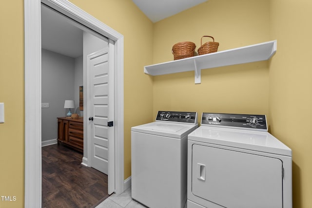 laundry room with washer and clothes dryer and wood finished floors