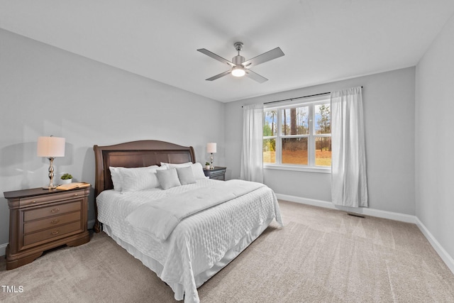 carpeted bedroom featuring baseboards and a ceiling fan