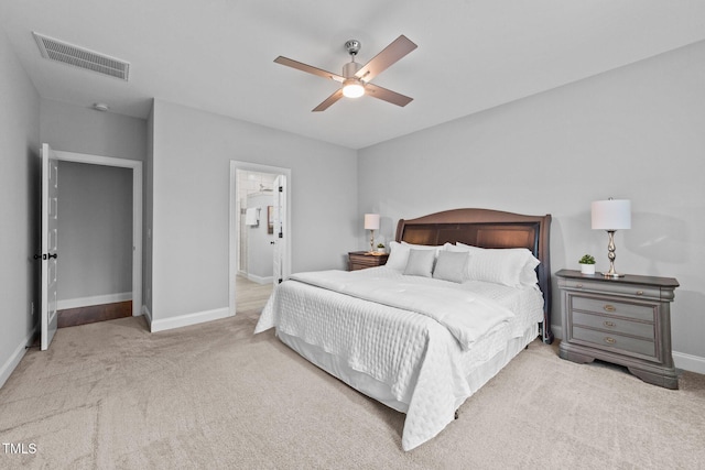 carpeted bedroom with baseboards, ceiling fan, and ensuite bathroom