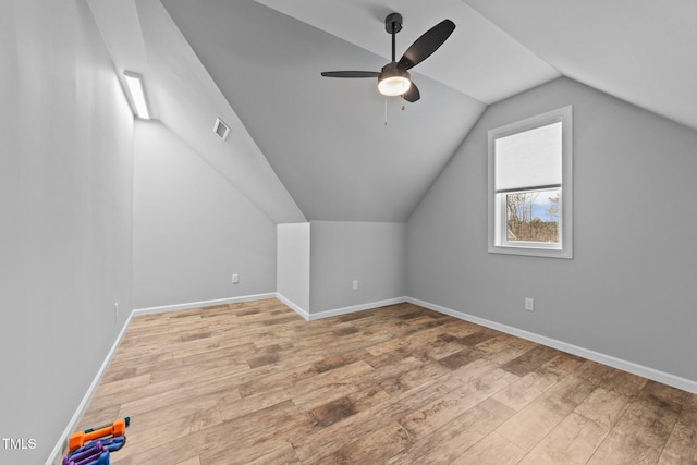 bonus room featuring vaulted ceiling, ceiling fan, wood finished floors, and baseboards