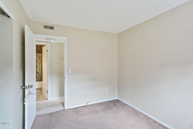 carpeted empty room featuring baseboards