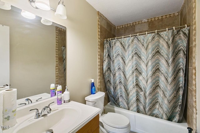 bathroom with vanity, toilet, shower / bath combo with shower curtain, and a textured ceiling