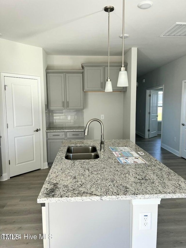 5134 Holly Hill Ct Lot 28, Battleboro, NC 27809 - kitchen with a sink, gray cabinetry, dark wood-style flooring, light stone counters, and an island with sink