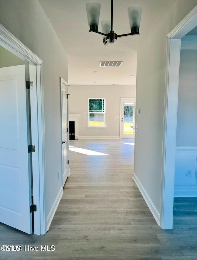 5134 Holly Hill Ct Lot 28, Battleboro, NC 27809 - corridor featuring wood finished floors, baseboards, and a chandelier