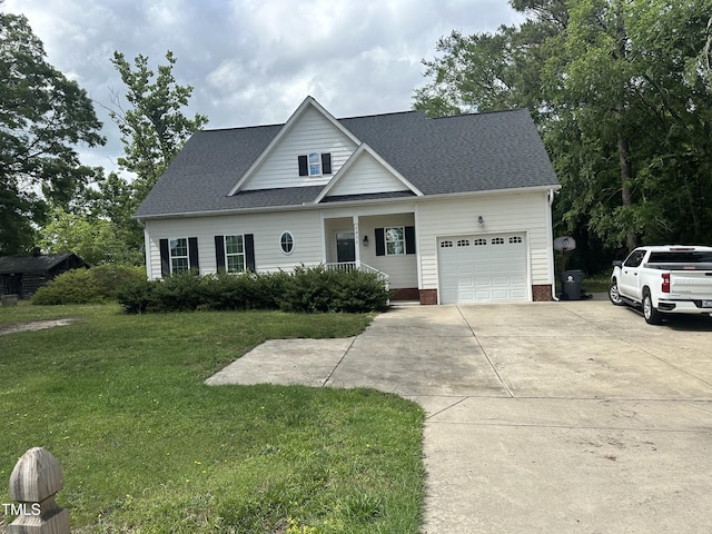traditional-style home with an attached garage, driveway, covered porch, a front yard, and a shingled roof