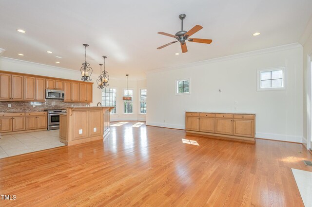 15 Treviso Pl, Durham, NC 27707 - kitchen featuring appliances with stainless steel finishes, crown molding, ceiling fan, light wood-type flooring, and decorative backsplash