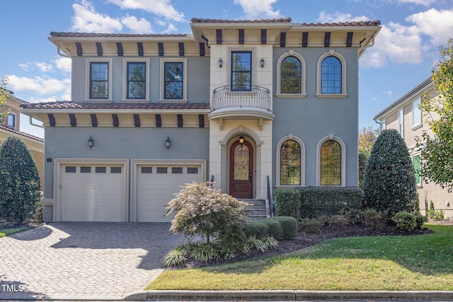 15 Treviso Pl, Durham, NC 27707 - mediterranean / spanish-style home featuring a balcony, an attached garage, decorative driveway, and stucco siding