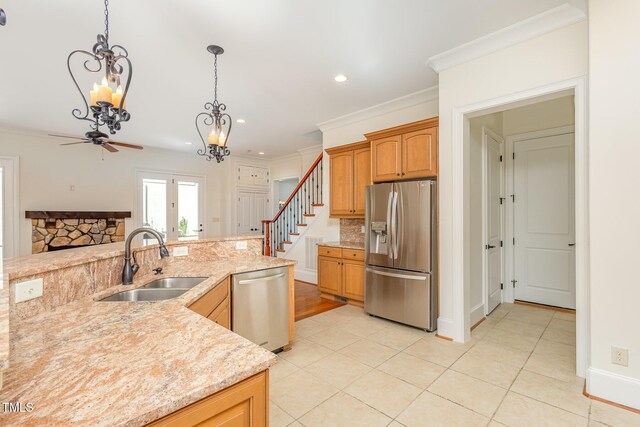 15 Treviso Pl, Durham, NC 27707 - kitchen with appliances with stainless steel finishes, a sink, a chandelier, light tile patterned floors, and a ceiling fan