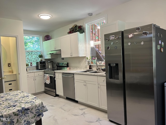 122 Button Rd, Morrisville, NC 27560 - kitchen with appliances with stainless steel finishes, under cabinet range hood, light marble finish floors, and plenty of natural light