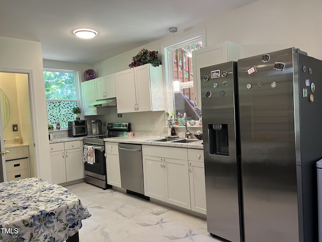 122 Button Rd, Morrisville, NC 27560 - kitchen featuring stainless steel appliances, light marble finish flooring, light countertops, and healthy amount of natural light