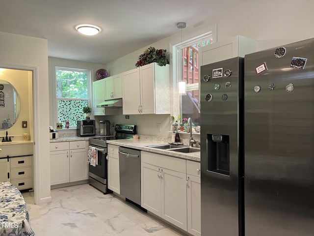 122 Button Rd, Morrisville, NC 27560 - kitchen featuring appliances with stainless steel finishes, under cabinet range hood, light marble finish floors, and white cabinets