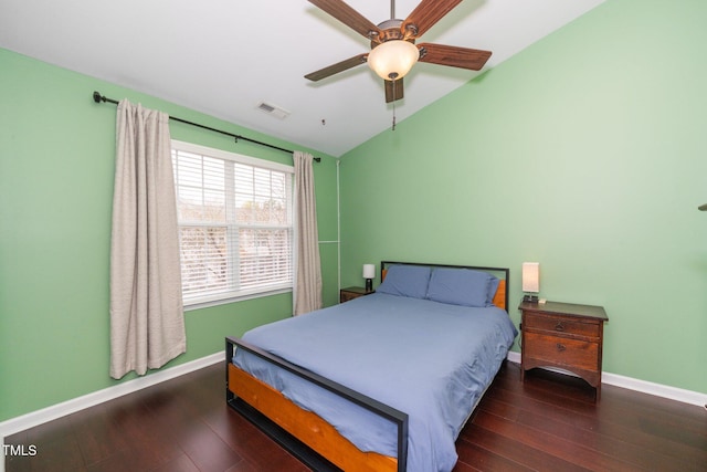 bedroom featuring vaulted ceiling, baseboards, wood finished floors, and ceiling fan