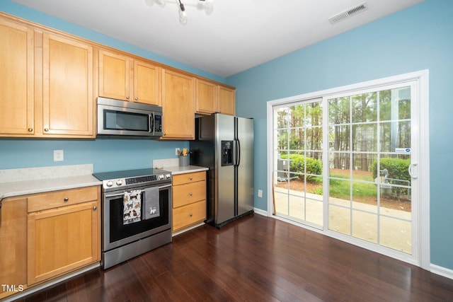 kitchen with stainless steel appliances, light countertops, dark wood-type flooring, and baseboards