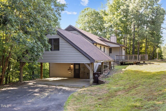 5900 Ebenezer Church Rd, Raleigh, NC 27612 - view of side of property with driveway, a carport, a chimney, roof with shingles, and a yard