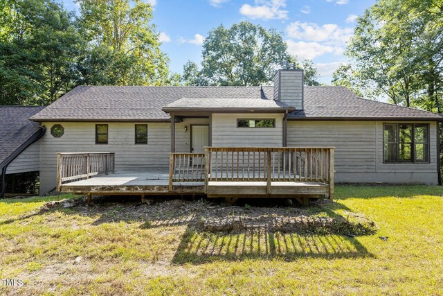 5900 Ebenezer Church Rd, Raleigh, NC 27612 - back of property featuring a chimney, a yard, roof with shingles, and a wooden deck