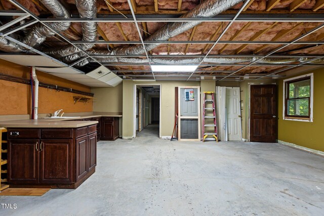 5900 Ebenezer Church Rd, Raleigh, NC 27612 - basement featuring a sink and baseboards