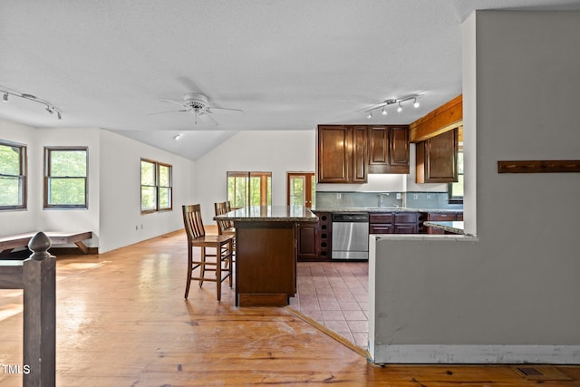 5900 Ebenezer Church Rd, Raleigh, NC 27612 - kitchen featuring stainless steel dishwasher, track lighting, a kitchen bar, a sink, and ceiling fan