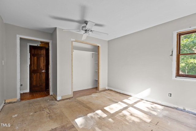 5900 Ebenezer Church Rd, Raleigh, NC 27612 - unfurnished bedroom featuring a closet, baseboards, wood finished floors, and ceiling fan