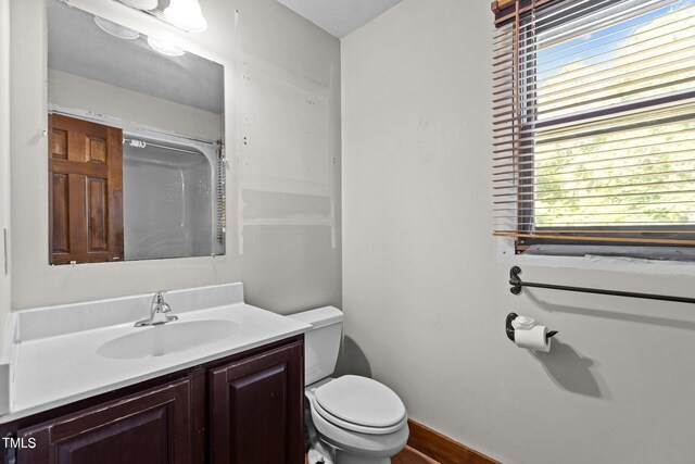 5900 Ebenezer Church Rd, Raleigh, NC 27612 - bathroom featuring toilet, vanity, and baseboards