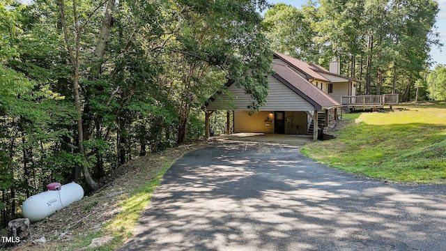 5900 Ebenezer Church Rd, Raleigh, NC 27612 - view of home's exterior featuring asphalt driveway, a chimney, a wooden deck, a lawn, and a detached carport