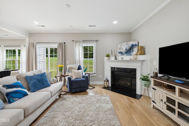2004 Tennessee Rd, Durham, NC 27704 - living room with wood finished floors, a fireplace with flush hearth, crown molding, recessed lighting, and baseboards