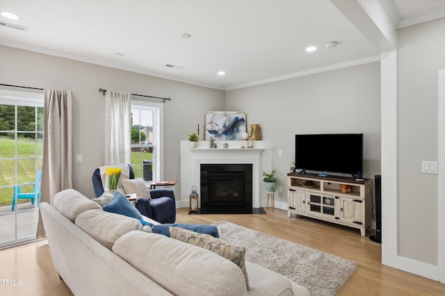 2004 Tennessee Rd, Durham, NC 27704 - living area with wood finished floors, a fireplace with flush hearth, crown molding, recessed lighting, and baseboards