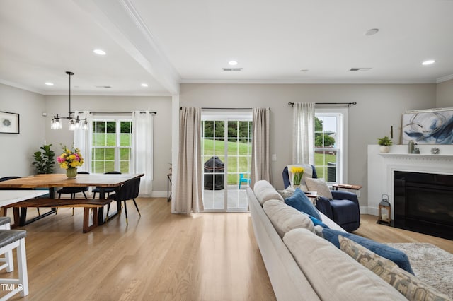 2004 Tennessee Rd, Durham, NC 27704 - living room with healthy amount of natural light, recessed lighting, light wood-style flooring, a glass covered fireplace, and ornamental molding